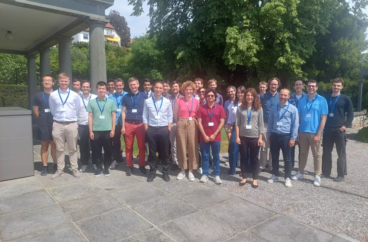 All the workshop participants stand in a group outside Zurich's Villa Hatt
