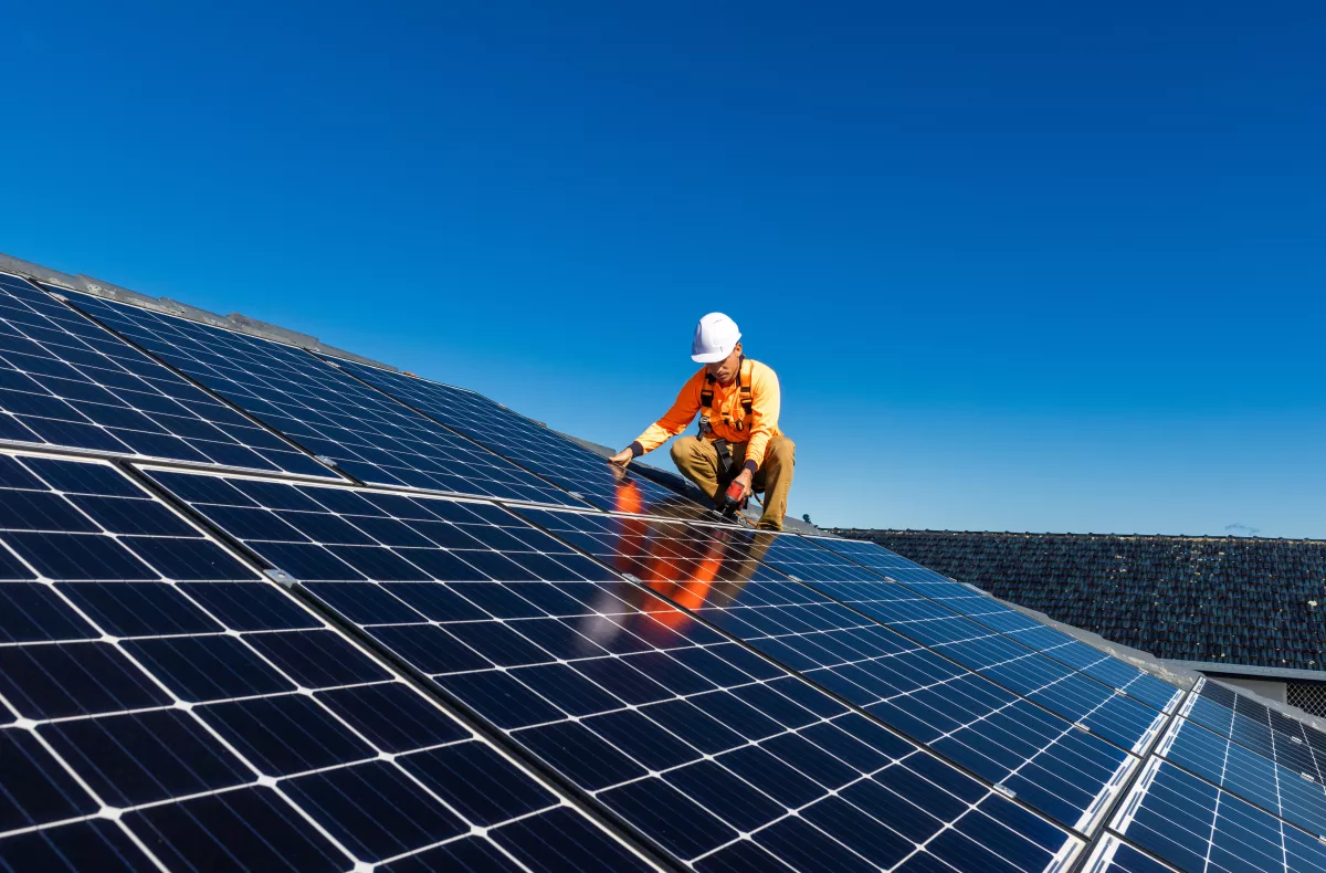 A man fixing solar panels