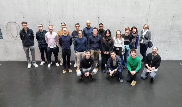 Group of fellowship holders standing in the entrance of the Empa NEST building