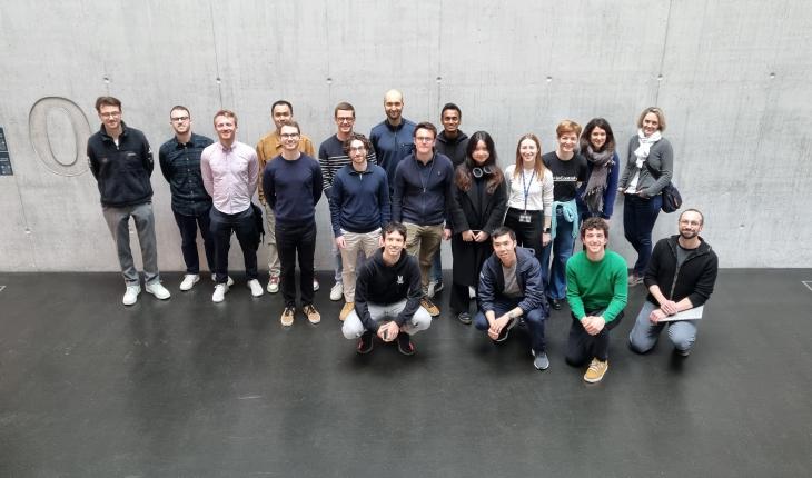 Group of fellowship holders standing in the entrance of the Empa NEST building