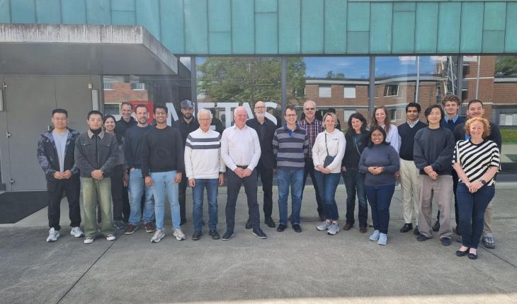 Group of people standing outside the METAS building