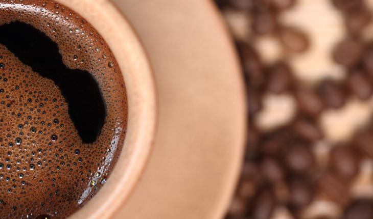 Coffee cup with bubbles swirling on the surface