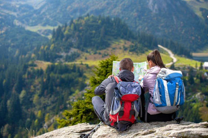 Two people looking at a map, deciding which path to take